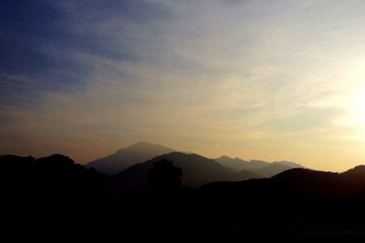 Scenic view of mountains against sky at sunset