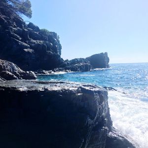 Scenic view of sea against clear blue sky