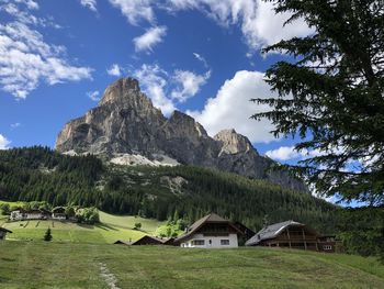 Houses on mountain against sky