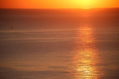 Scenic view of sea against orange sky