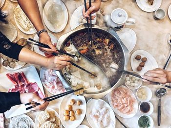 High angle view of people having food on table