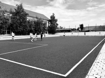 People playing in park against sky