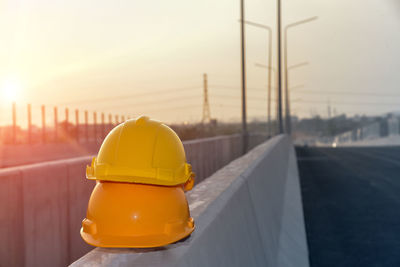 Close-up of yellow car on road against sky during sunset