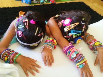Girls wearing colorful bracelets and hair clips