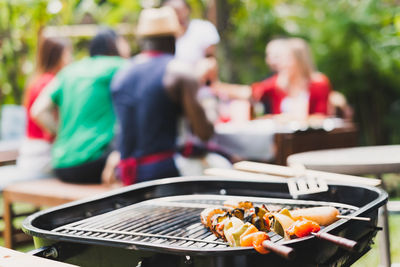 People standing on barbecue grill