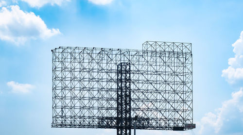 Low angle view of crane against sky