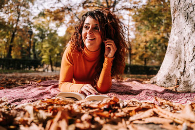 Young woman sitting on book