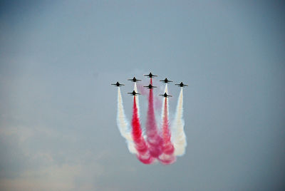 Low angle view of airshow against clear sky