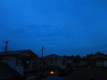 Houses against sky at night