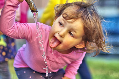 Portrait of cute girl holding outdoors