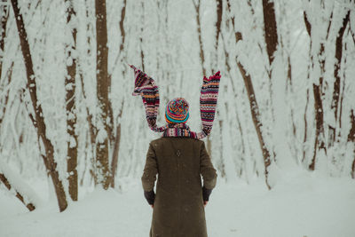 Rear view of woman standing against 