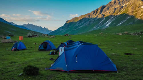 Scenic view of tent and mountains against sky