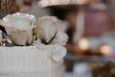 Close-up of wedding cake with roses 