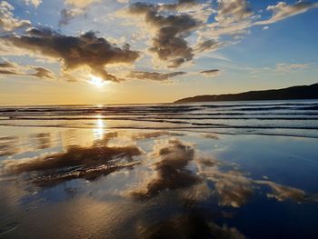 Scenic view of sea against sky at sunset