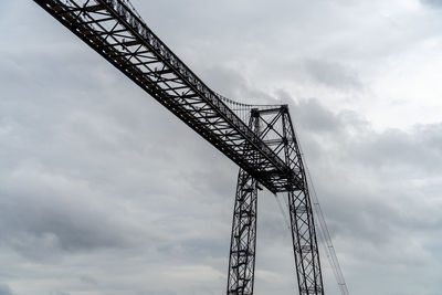 Transporter bridge over the charente river under a cloudy sky. national monument. rochefort sur mer