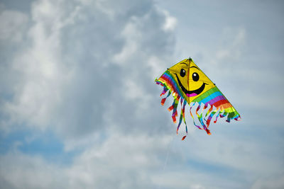 Low angle view of kite flying against sky