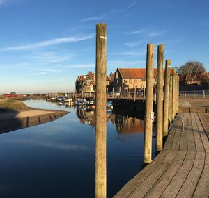 Pier over river against sky