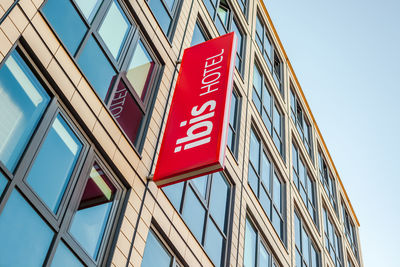 Low angle view of text on building against sky