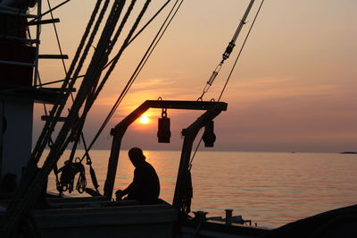 Boat in sea at sunset