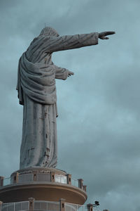 Low angle view of statue against cloudy sky