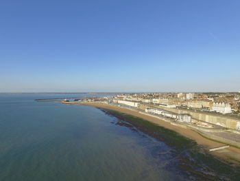 Scenic view of beach against clear blue sky