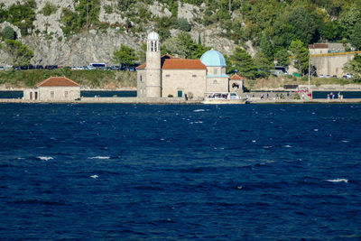 Historic building by sea against city