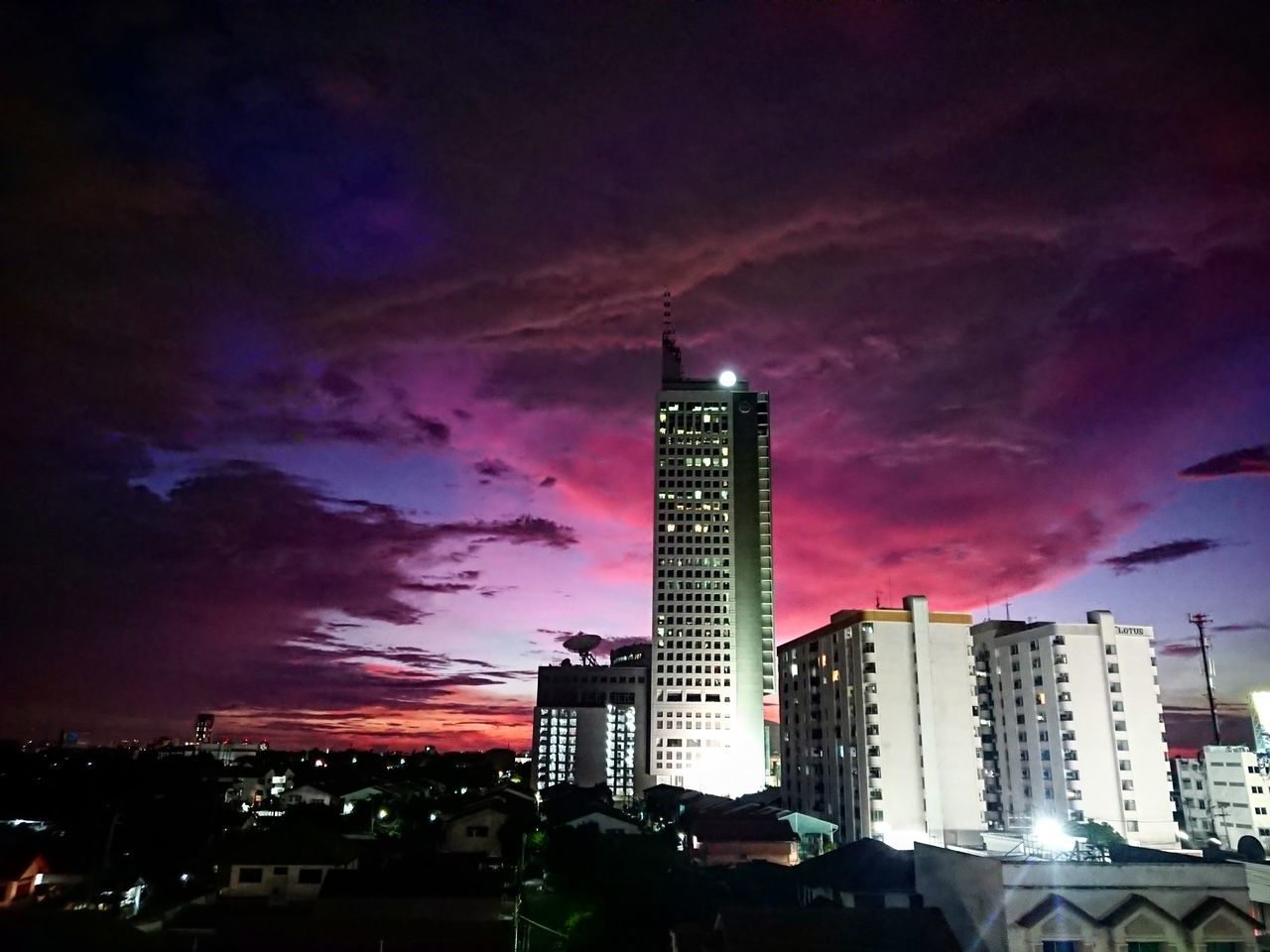 LOW ANGLE VIEW OF ILLUMINATED BUILDINGS AGAINST SKY