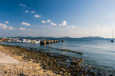 Harbor in sea against sky