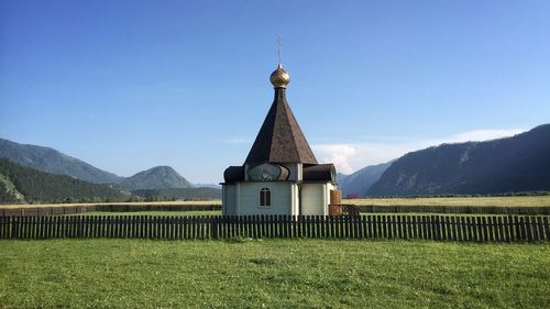 View of temple against building and mountains