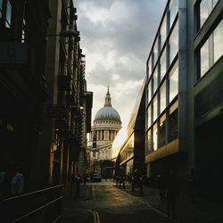 Buildings against cloudy sky