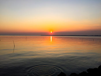 Scenic view of sea against romantic sky at sunset