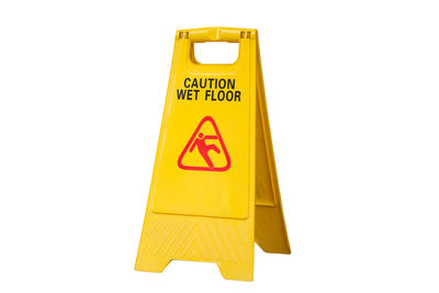 Close-up of caution sign on white background