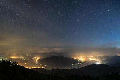 Scenic view of silhouette mountains against sky at night