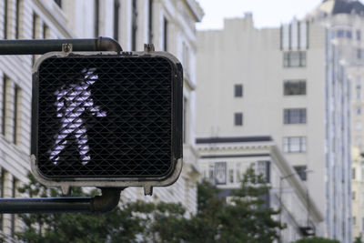 Low angle view of road signal against buildings