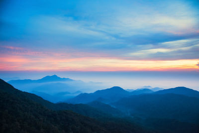 Scenic view of silhouette mountains against sky during sunset