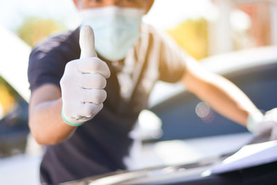 Close-up of hand holding car against blurred background