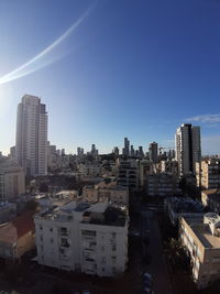 Modern buildings in city against clear sky