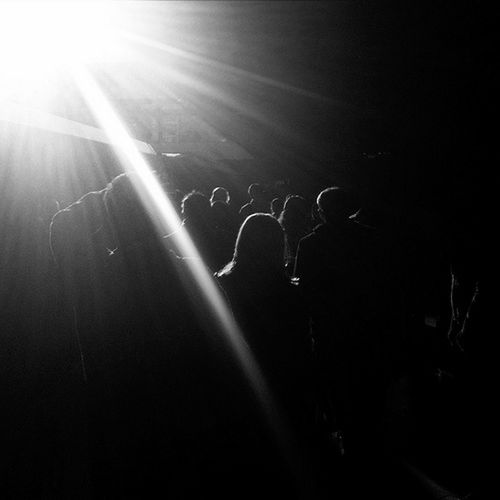 large group of people, silhouette, lens flare, light - natural phenomenon, illuminated, crowd, arts culture and entertainment, night, enjoyment, performance, lifestyles, nightlife, leisure activity, music festival, men, fun, togetherness, light beam, concert