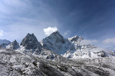 Scenic view of mountains against cloudy sky