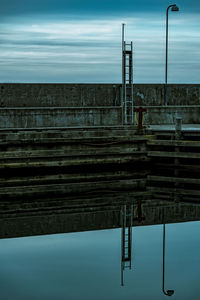 Pier over river against sky