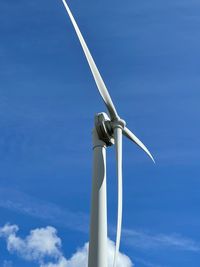 Low angle view of windmill against sky