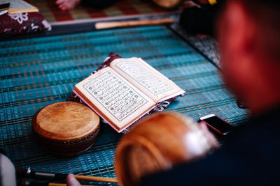 Close-up of man by religious book