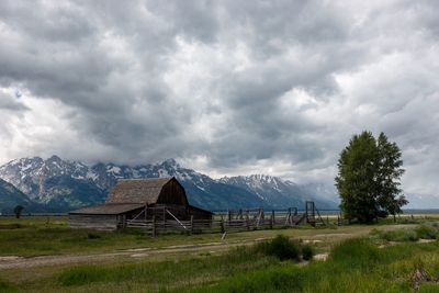 Built structure on field against sky