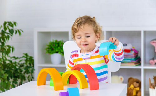 Portrait of cute girl playing with toy blocks