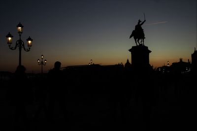 Silhouette of statue against sky at night