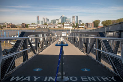 Bridge over river against buildings in city