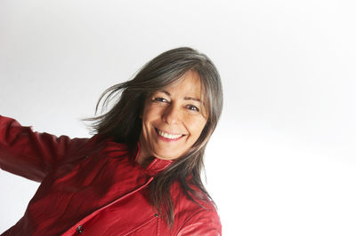 Young woman standing against white background