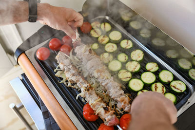 Meat on skewers with vegetables on the barbecue