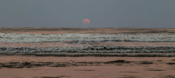 Scenic view of sea against clear sky during sunset