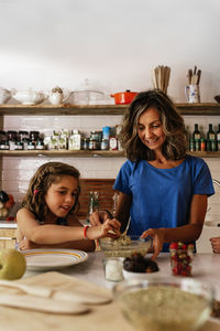 Portrait of smiling girl with ice cream on table